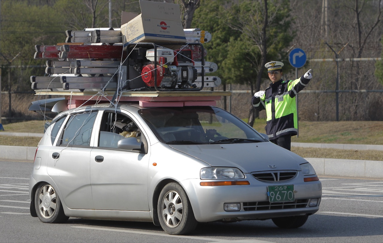 The overloaded cars of South Korean workers fleeing North Korea