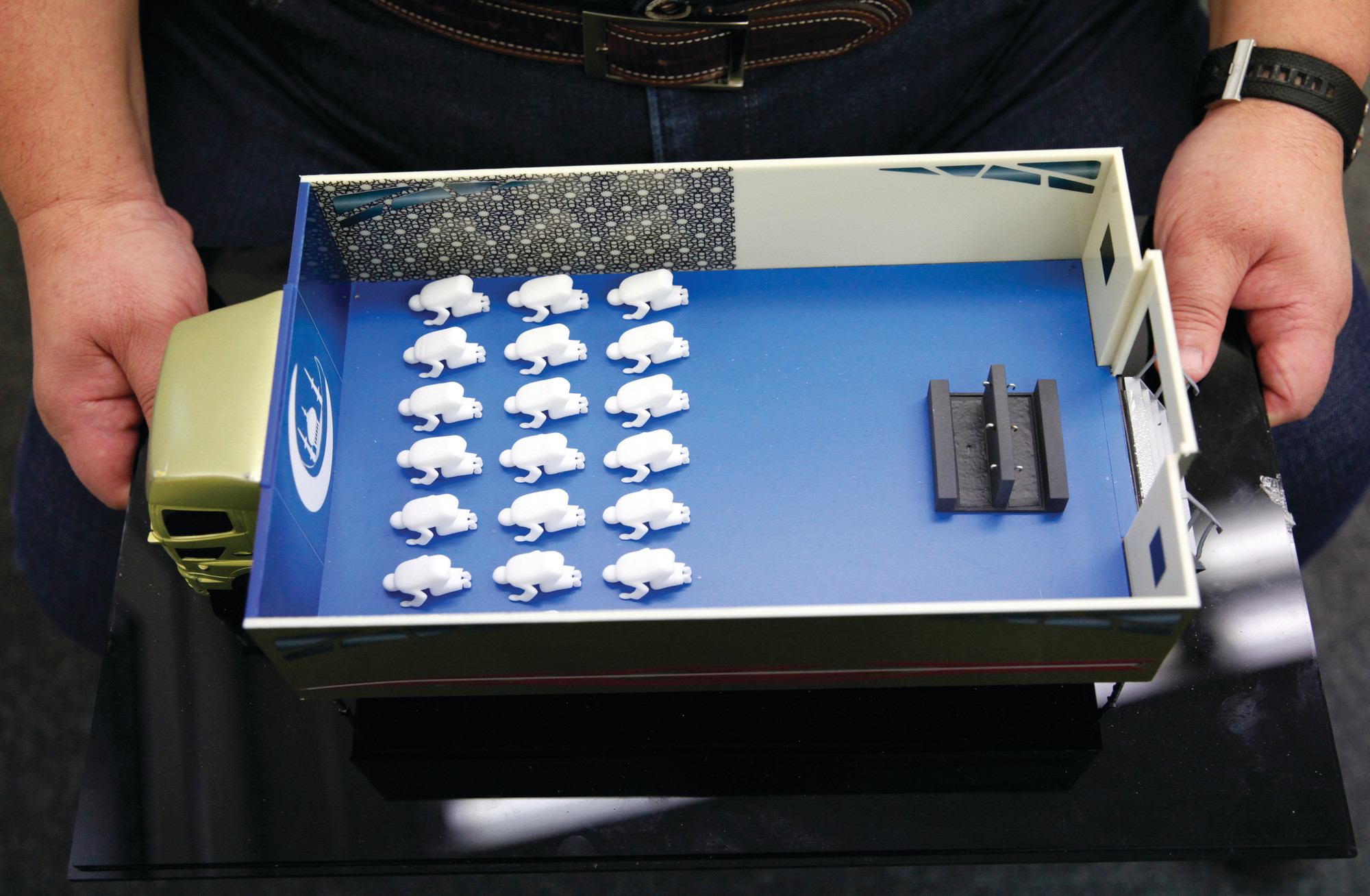 In this July 20, 2018, photo, Yasuharu Inoue, chairman of Mobile Mosque Executive Committee, shows a scale model of Mobile Mosque, a mosque on wheels with the capacity for up to 50 people in Tokyo. As Japan prepares to host visitors from around the world for the Summer Olympics in 2020, a Tokyo sports and cultural events company has created a mosque on wheels that its head hopes will make Muslim visitors feel at home. (AP Photo/Nicola Shannon)
