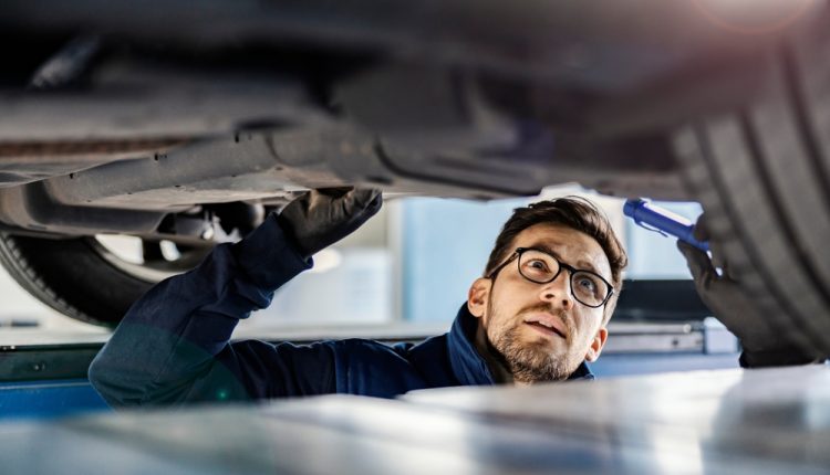 An,Expert,For,Cars,Examining,Car,In,Mechanic’s,Pit.