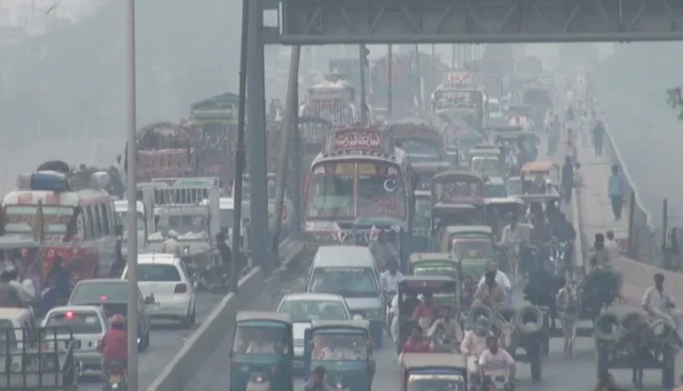Smog-covered Islamabad road with visible diesel trucks, highlighting poor air quality.